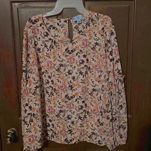 Light pink top with flowers. Keyhole button on back.